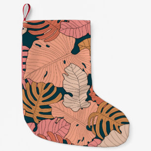 Heldere roze, oranje, gele bladeren van monstera e kleine kerstsok