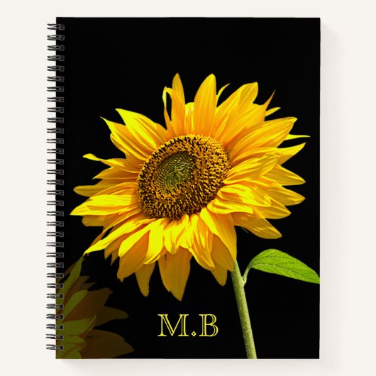 Heldere zonnebloem op zwarte achtergrond notitieboek (Voorkant)