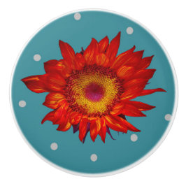 Helderrode zonnebloem op blauwe keramische knol knop