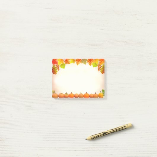 Herfstbladeren en pompoenen op scroll post-it® notes (Op bureau)