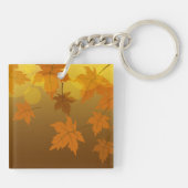Herfstpatroon met vallende esdoornbladeren en boke sleutelhanger (Achterkant)