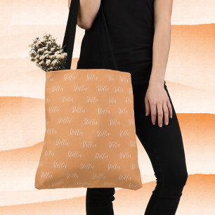 Herhalende naam in witte all-over abrikoos tote bag