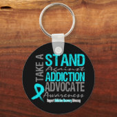 Herstel van toewijzing neemt een standpunt in tege sleutelhanger (Voorkant)