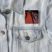 Het fluitje van een scheidsrechter ligt bovenop ee vierkante button 5,1 cm (In situ)