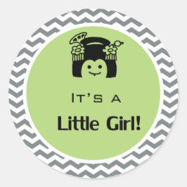 Het is een meisje groene, grijze sticker. ronde sticker