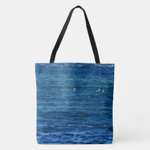 Het verkopen van slokken over de baai op een tote bag