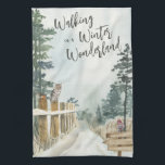 Het winterlandschap loopt in een winterland theedoek<br><div class="desc">Winterkeukenhanddoek voor het landschap,  met de letters "Walking in a Winter Wonderland" in trendy script-typografie. Dit rotsachtige landontwerp heeft een waterverf scène uit een sneeuwbos,  dennenbomen,  een rover en een uil op de hek.</div>