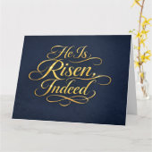 Hij Is Opgestaan – Elegante Gouden Script Paasfees Kaart (Gele Bloem)