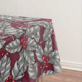 Holly berry, grijze bladeren op donkerrood tafelkleed (Voorbeeld)