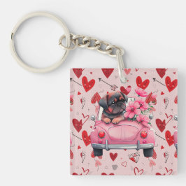 Hond in een auto met hart sleutelhanger