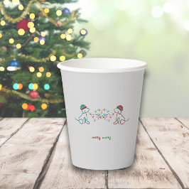 Honden spelen met kerstverlichting papieren bekers