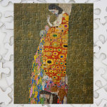 Hope II van Gustav Klimt,  Art Nouveau Legpuzzel<br><div class="desc">Hope II (1907/08) van Gustav Klimt is een Victoriaans schilderij van het symbolisme in het tijdperk van het symboliek, met een kunstschilderij van een zwangere dame die over haar grote buik naar een menselijke schedel kijkt. Er zijn drie vrouwen in de buurt van haar voeten die in het ingewikkelde patroon...</div>