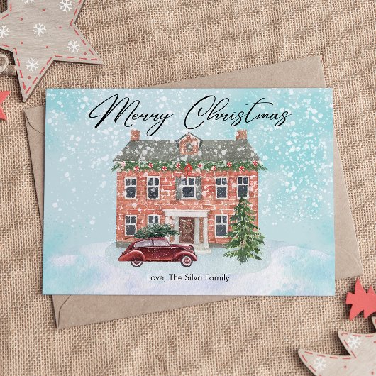 Huiselijk huis en besneeuwde kerst plat ontwerp feestdagenkaart