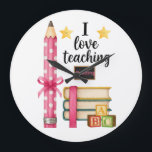 I love teaching reading teacher clock grote klok<br><div class="desc">Cute reading teacher design with pencil and books. Perfect for teachers who love helping students learn to read.</div>