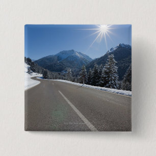 Idyllische lege weg door een winterlandschap, vierkante button 5,1 cm