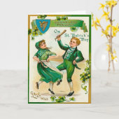 Iers jongen en meisje die op St. Patrick Dag Kaart (Gele Bloem)