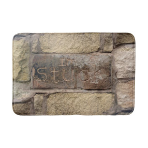 "Ik ben Stuck" een andere steen in de muur Badmat