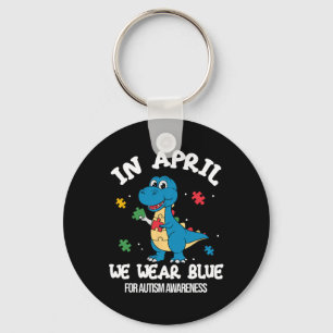 In april dragen we blauwe dinosaurus autisme bewus sleutelhanger