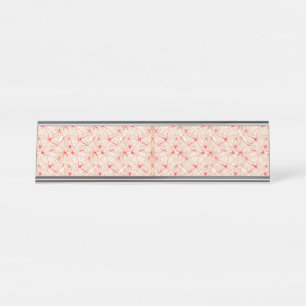 inpakpapier met een herhalend rood patroon, of bureau naambordje