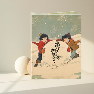 Japanse kinderen rollen een grote sneeuwbal kaart