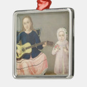 Jonge meid met gitaar en kind met een metalen ornament (Links)