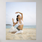 Jonge vrouw die op het strand yoga doet poster (Voorkant)