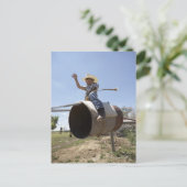 Jongen (8-10) die een geïmproviseerde rodeo bull g briefkaart (Staand voorkant)