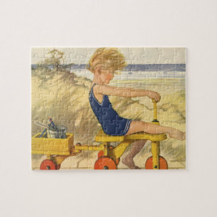 jongen die aan de strand met zandspeelgoed speelt legpuzzel