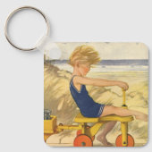  jongen die aan de strand met zandspeelgoed speelt sleutelhanger (Voorkant)