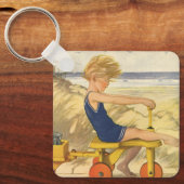  jongen die aan de strand met zandspeelgoed speelt sleutelhanger (Voorkant)