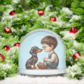 Jongen en teckel puppy sneeuwbol (Kerstmis)