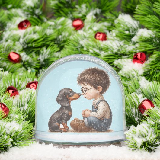 Jongen en teckel puppy sneeuwbol (Kerstmis)