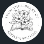 Jouw naam Boek & Bloemen Ex Libris Boekplaat Ronde Sticker<br><div class="desc">Modern, bloemetjesontwerp. Perfect voor het toevoegen van een persoonlijke touch aan uw gekoesterde boek collectie. Het ontwerp toont een open boek dat explodeert met bloemen en bladeren. De woorden 'Uit de Bibliotheek van' vormen een boogvormige rand en onder het boek jouw naam komt in klassieke seriële letters voor. Een prachtig...</div>
