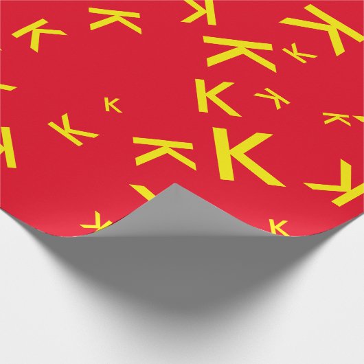 K aangepaste letter - gele naam-initiaal op rood cadeaupapier (Hoek)