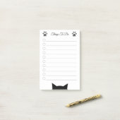 Kat kop en poetsen om dingen te doen post-it® notes (Op bureau)