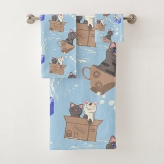 Katten in doos en melkdruppels op blauw bad handdoek