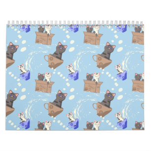 Katten in doos en melkdruppels op blauw kalender