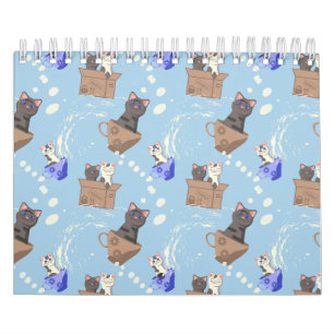 Katten in doos en melkdruppels op blauw kalender