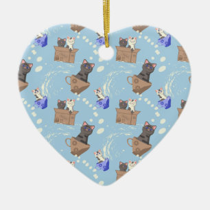 Katten in doos en melkdruppels op blauw keramisch ornament