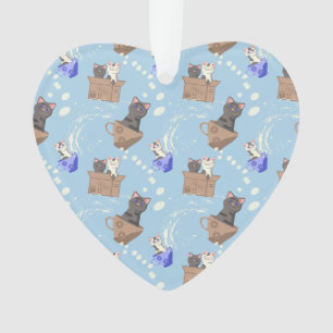 Katten in doos en melkdruppels op blauw ornament