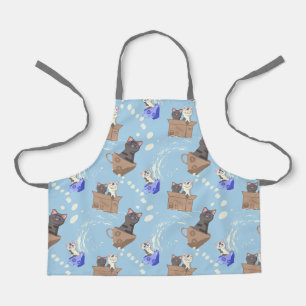 Katten in doos en melkdruppels op blauw schort