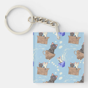 Katten in doos en melkdruppels op blauw sleutelhanger