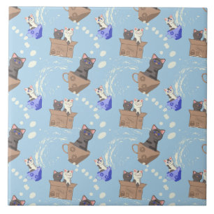 Katten in doos en melkdruppels op blauw tegeltje