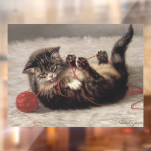 Kattenwiegje, een kat die speelt met een bol garen raamsticker