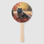 Keeshond in herfstbladeren valt inspireren  handwaaier (Achterkant)