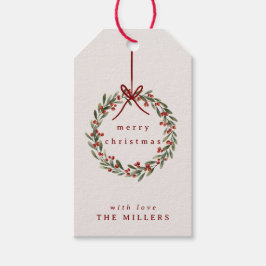 Kerst gebladerte krans met rode boog cadeaulabel