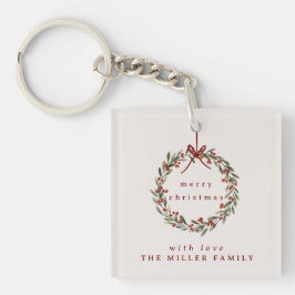 Kerst gebladerte krans met rode strik. sleutelhanger