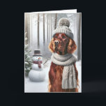 Kerst Ierse Setter met Sneeuwman Kaart<br><div class="desc">Een hond met een grijs gebreid pet en sjaal staat in een besneeuwd bos naast een sneeuwpop voor de kerst</div>