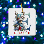 Kerst Rendier Monogram Letter E Aangepaste naam Keramisch Ornament<br><div class="desc">Breng feestelijke charme naar uw vakantie-inrichting met dit gepersonaliseerde E-Monogram kerstornament! Met een speels E-monogram toont dit ontwerp een vrolijk kerstrendier gekleed in een gezellig winterse pet en sjaal, omringd door een prachtig arrangement van rode, witte en blauwe winterbloemen. Met een bewerkbare naamruimte is dit ornament ideaal als een gepersonaliseerd...</div>