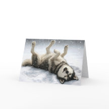 Kerst Siberische Husky maakt een sneeuwengel